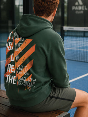 Hoodie-Strive-X-Bottle-green-model-zittend-op-een-bankje